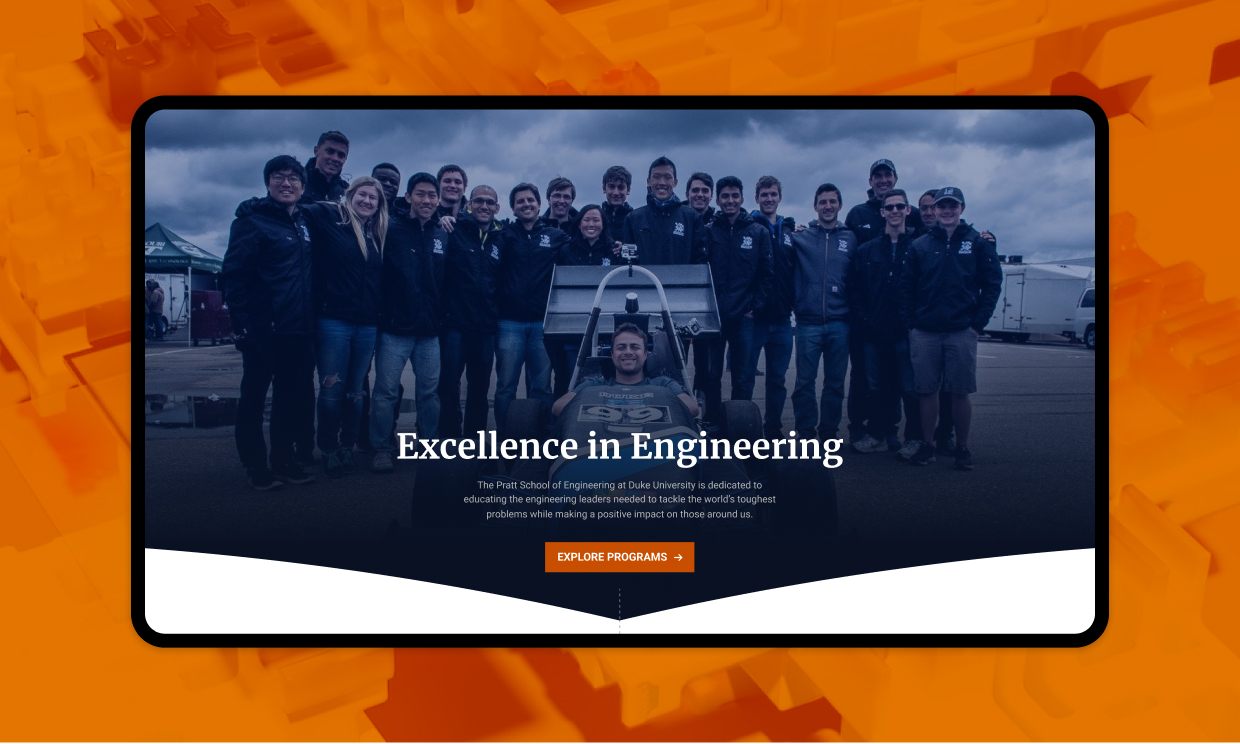 Group photo of the duke engineering team with one student in a race car.