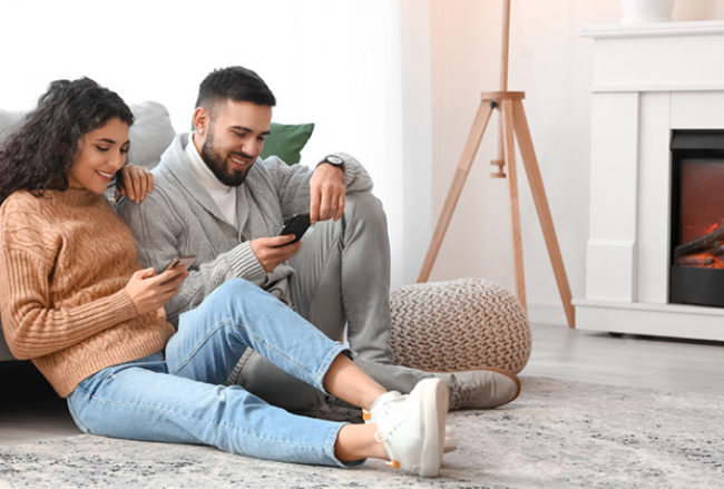 A couple happily lounging in their living room