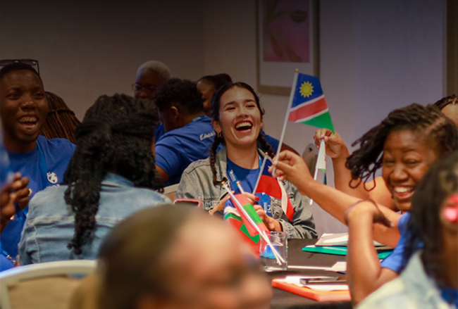 Group of happy people waving various countries' flags
