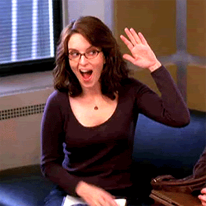 Tina Fey as Liz Lemon giving herself an awesome high five.